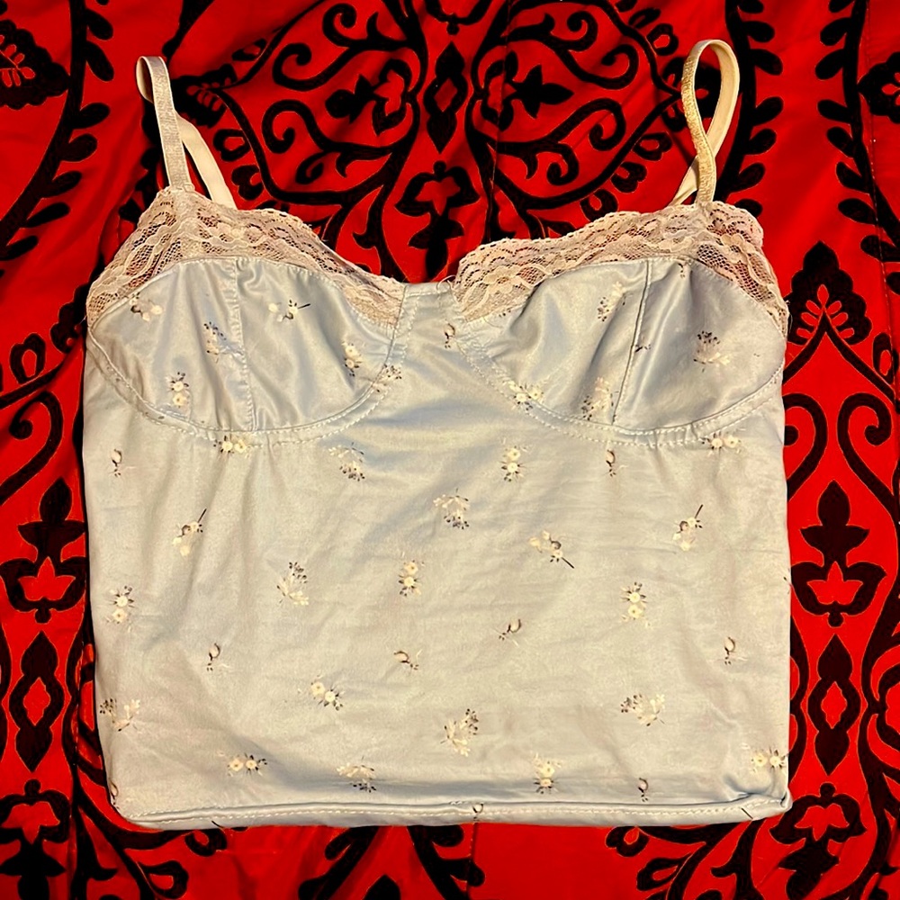 This is a baby blue crop top with flower design. It is a size medium